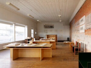 interior view of Architecture Office with brick walls and wood tables