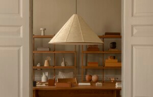 beige lamp hanging in front of wooden case