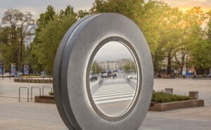 Circular stone sculpture with a mirror like circle in the middle.