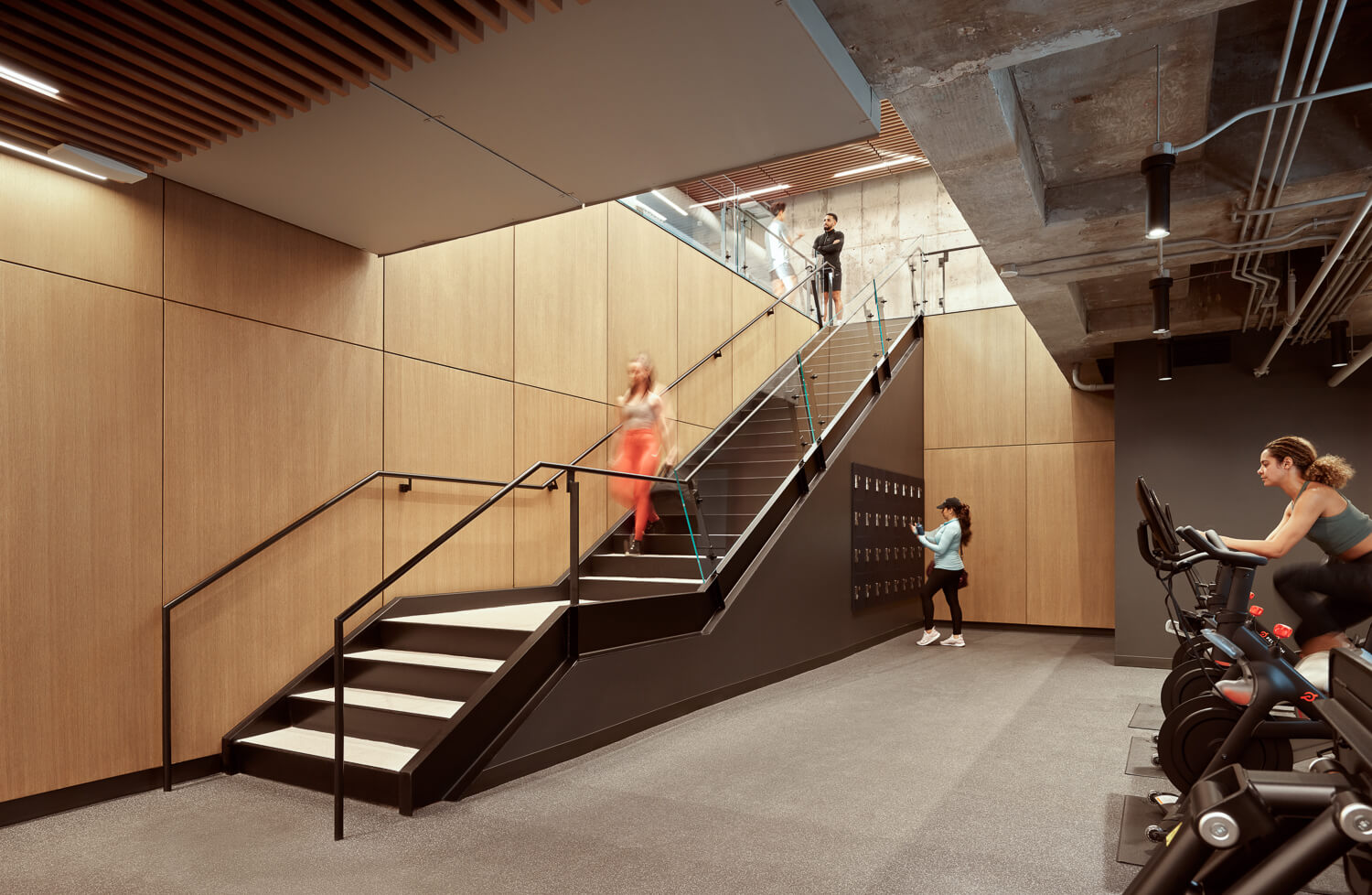 staircase going down to a gym and workout space