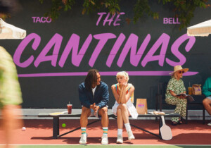 people sitting on bench on pickeball court at Taco Bell The Cantinas